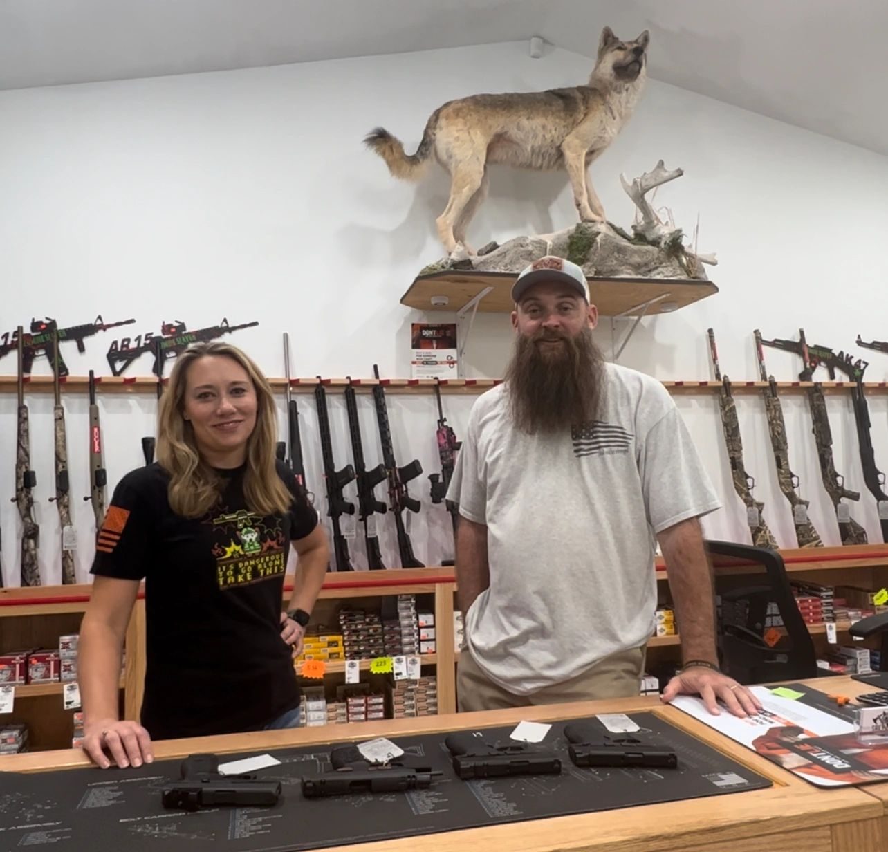 The Haughts behind the counter of Lady Grey Armament, their family gun shop in Tyler County, West Virginia